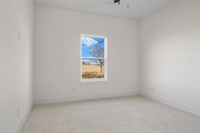 unfurnished room featuring ceiling fan and carpet flooring