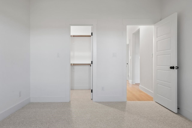 unfurnished bedroom with a spacious closet and a closet