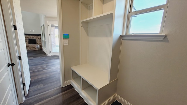 mudroom with a fireplace and dark hardwood / wood-style floors