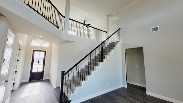 entrance foyer with dark hardwood / wood-style floors and a high ceiling