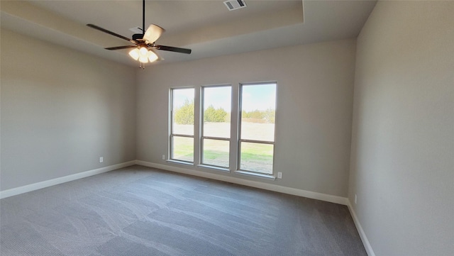 carpeted spare room with ceiling fan