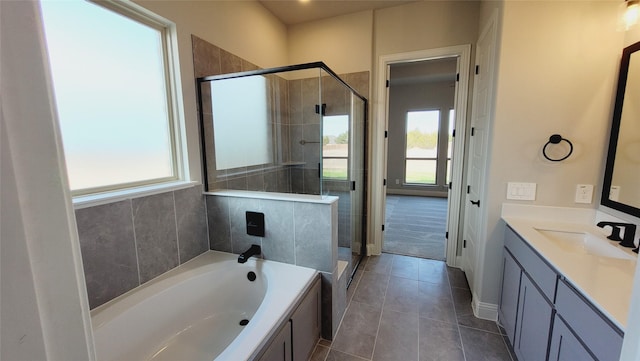 bathroom featuring vanity, a wealth of natural light, tile patterned floors, and independent shower and bath