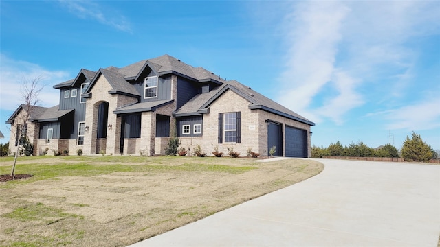 view of front of house with a garage and a front lawn