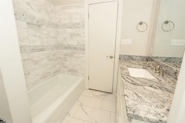 bathroom with vanity and tiled shower / bath