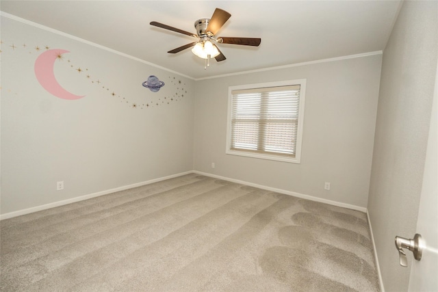 empty room featuring crown molding, ceiling fan, and carpet flooring