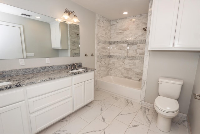 full bathroom featuring tiled shower / bath, vanity, and toilet