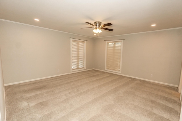 carpeted empty room featuring crown molding and ceiling fan