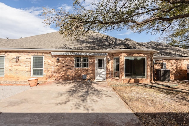 view of front of property with central AC and a patio area