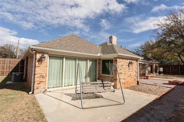 rear view of property featuring central AC and a patio