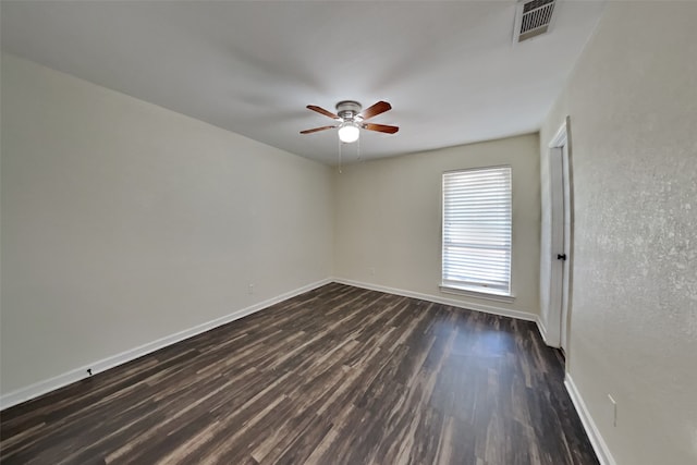 unfurnished room featuring dark wood-type flooring and ceiling fan