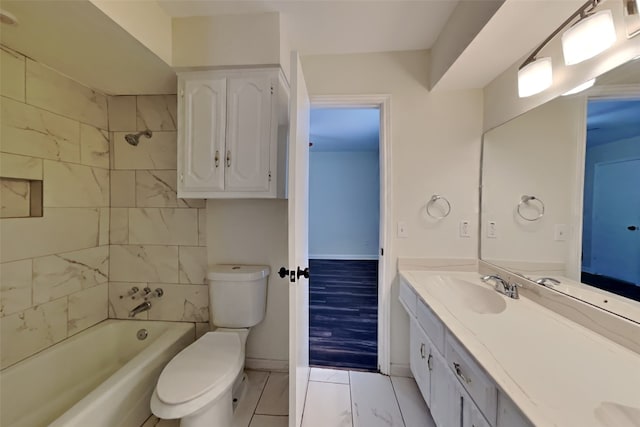 full bathroom with tiled shower / bath, vanity, and toilet