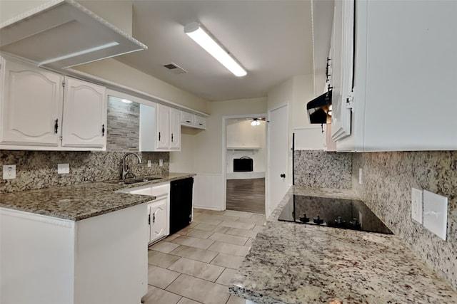 kitchen with white cabinetry, sink, black appliances, and stone counters