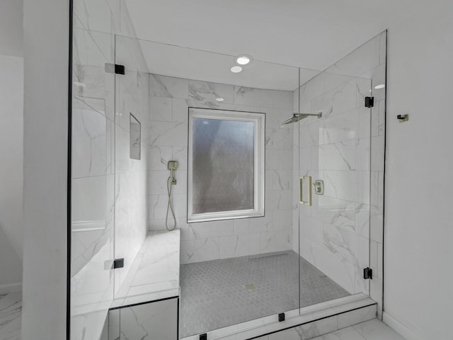 bathroom with a shower with door