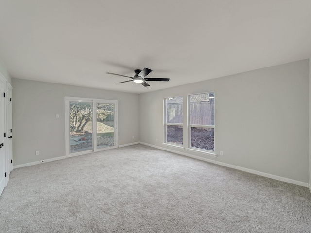 empty room featuring ceiling fan and carpet flooring