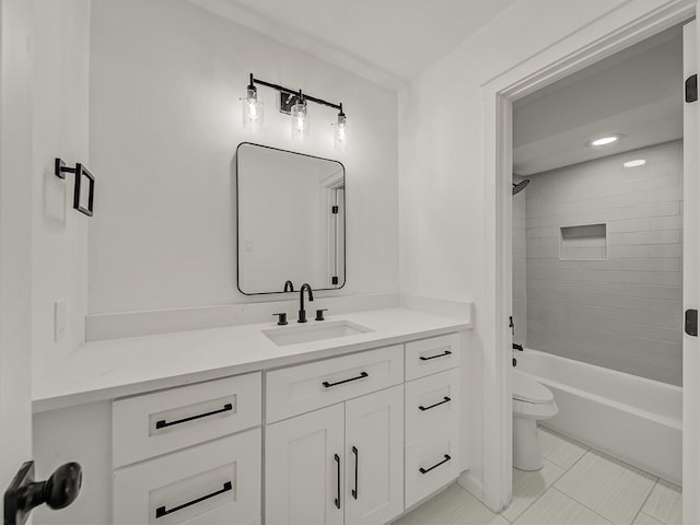 full bathroom featuring tile patterned flooring, tiled shower / bath, vanity, and toilet