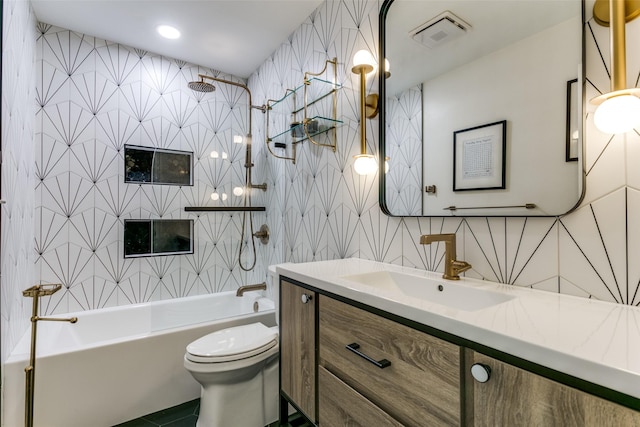 full bathroom with shower / bathing tub combination, vanity, tile walls, and toilet