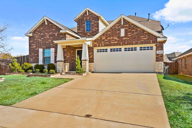 craftsman inspired home with a front yard, an attached garage, fence, and brick siding