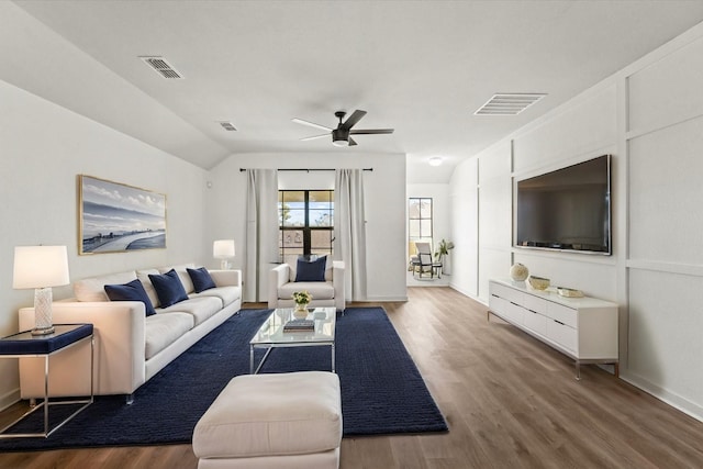 living room featuring ceiling fan, wood-type flooring, and vaulted ceiling