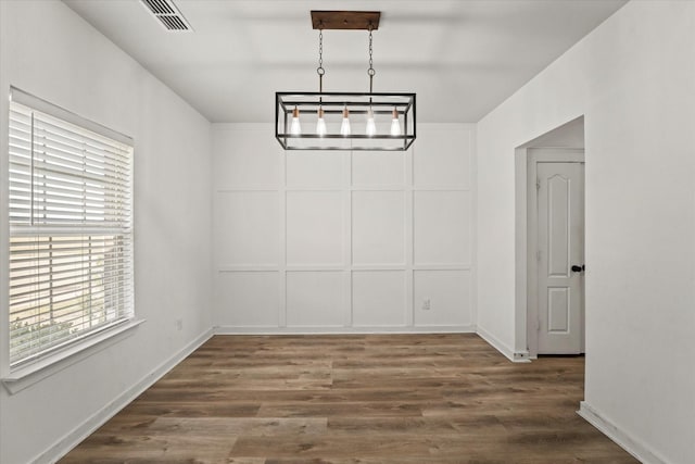 unfurnished dining area with dark hardwood / wood-style floors