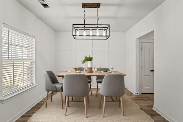 dining area with dark hardwood / wood-style flooring