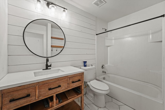 full bathroom with wood walls, tiled shower / bath combo, vanity, toilet, and tile patterned floors