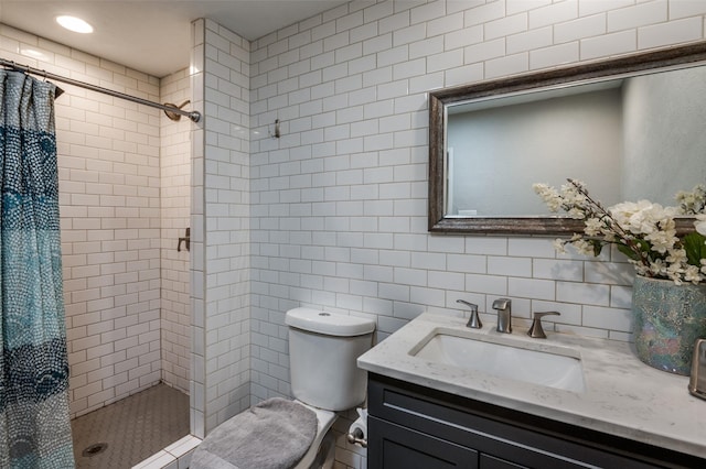 bathroom with vanity, a shower with curtain, toilet, and tile walls