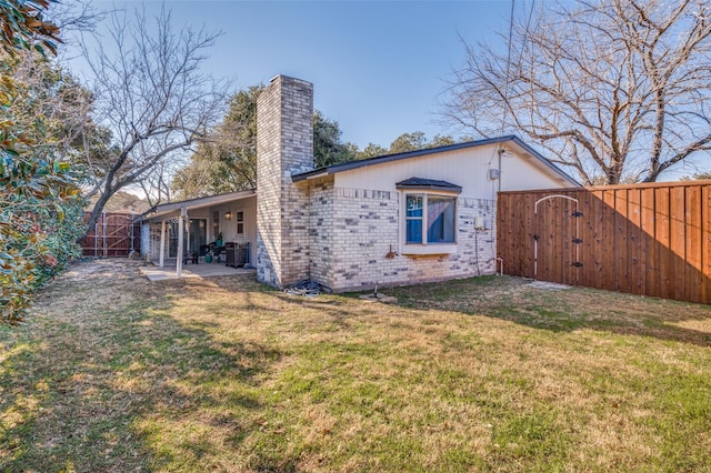 back of house with cooling unit, a yard, and a patio area