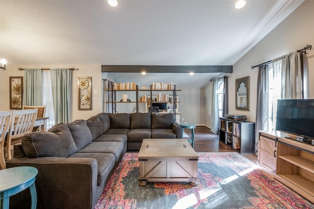 living room featuring lofted ceiling and dark hardwood / wood-style flooring