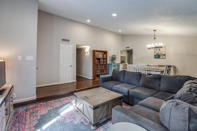 living room featuring high vaulted ceiling, a chandelier, and dark hardwood / wood-style flooring