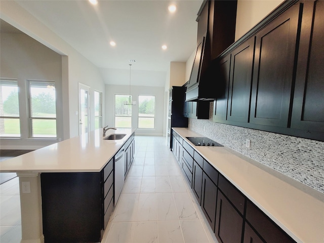 kitchen with lofted ceiling, sink, tasteful backsplash, a center island with sink, and dishwasher