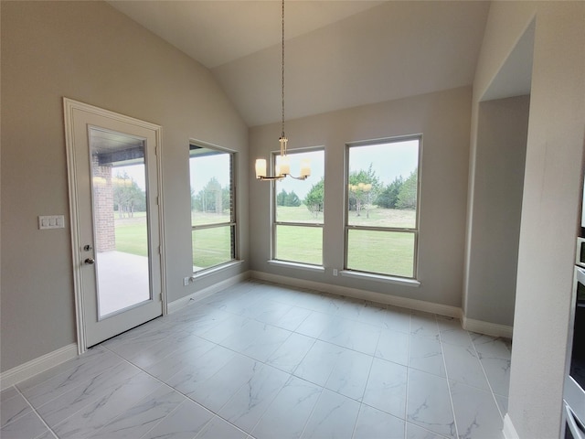 unfurnished dining area featuring an inviting chandelier and vaulted ceiling