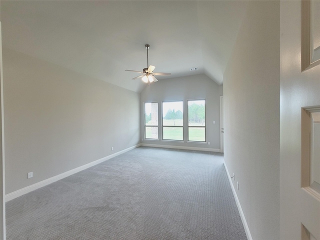 carpeted empty room with lofted ceiling and ceiling fan