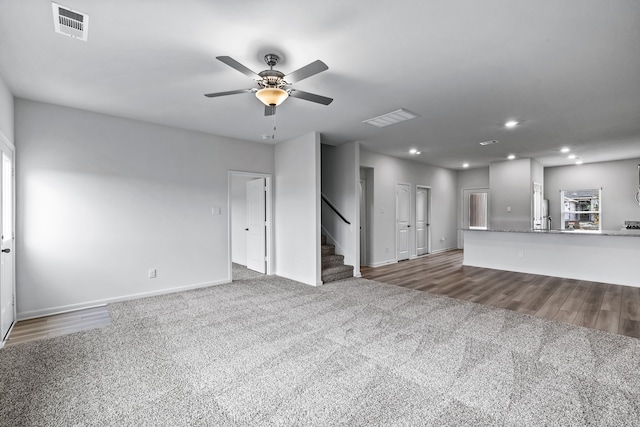 unfurnished living room with carpet flooring and ceiling fan