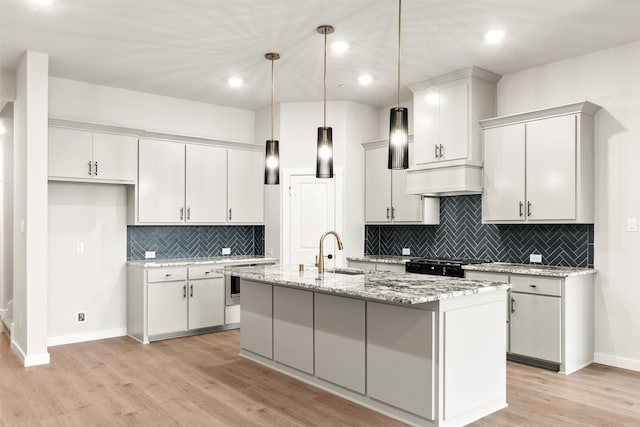604 Tall Grass Trl, Wylie, TX 75098 - kitchen featuring a sink, baseboards, light wood-type flooring, range, and backsplash