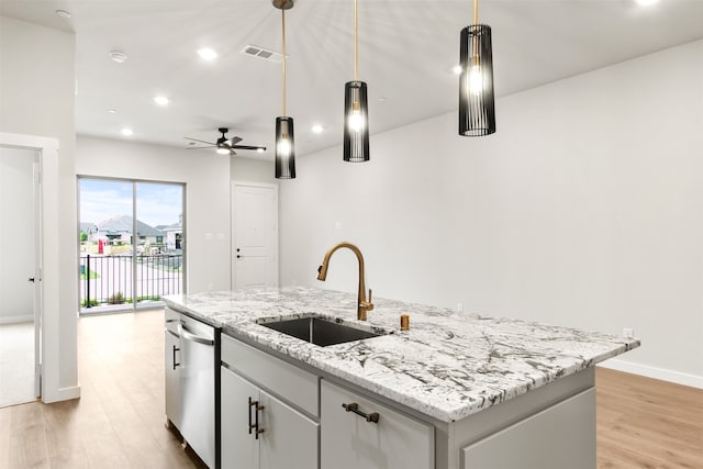 604 Tall Grass Trl, Wylie, TX 75098 - kitchen with a sink, stainless steel dishwasher, a center island with sink, ceiling fan, and light wood-type flooring