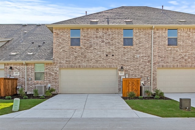 604 Tall Grass Trl, Wylie, TX 75098 - view of front of property featuring brick siding, concrete driveway, an attached garage, and central AC unit