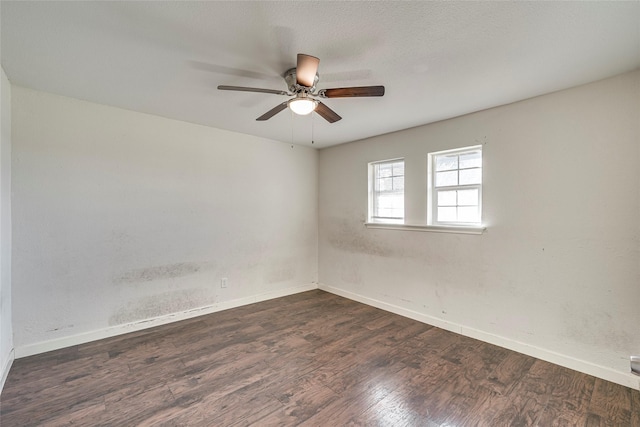 unfurnished room featuring dark hardwood / wood-style flooring and ceiling fan