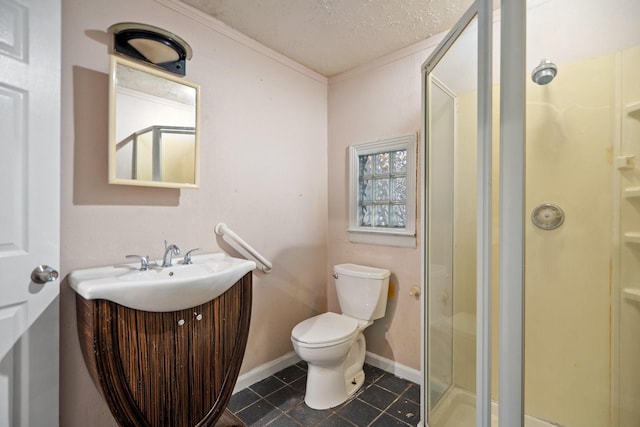 bathroom with a shower with door, vanity, ornamental molding, a textured ceiling, and toilet