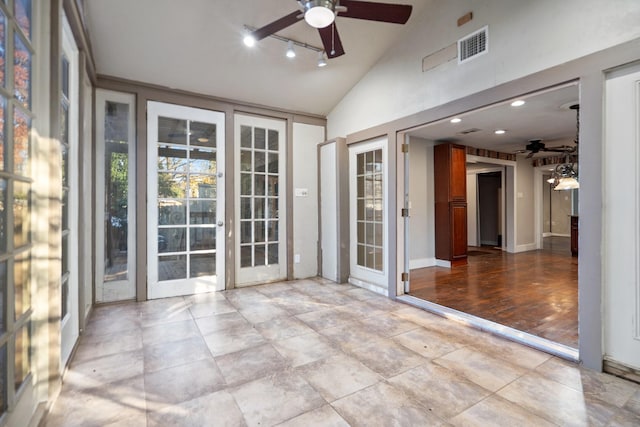 unfurnished sunroom with vaulted ceiling, french doors, ceiling fan, and track lighting