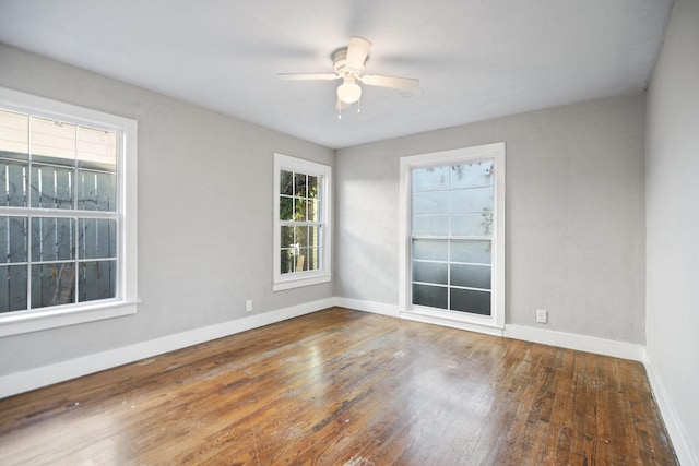 empty room featuring dark hardwood / wood-style floors and ceiling fan