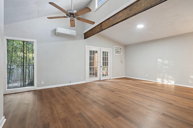 unfurnished room with wood-type flooring, vaulted ceiling with beams, a wall mounted air conditioner, and french doors