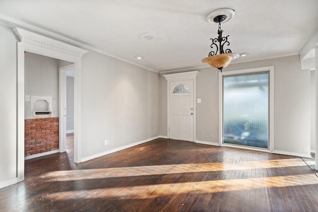 foyer with dark wood-type flooring and ornamental molding