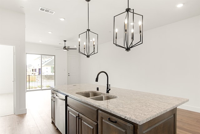 606 Tall Grass Trl, Wylie, TX 75098 - kitchen with a sink, stainless steel dishwasher, a kitchen island with sink, light wood-style flooring, and a chandelier