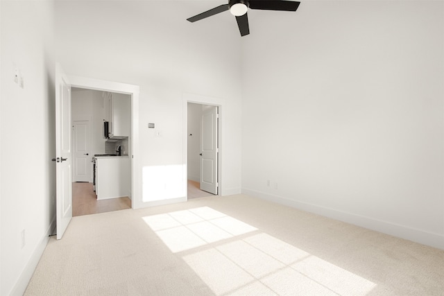 606 Tall Grass Trl, Wylie, TX 75098 - unfurnished bedroom with light carpet, a high ceiling, baseboards, and ceiling fan