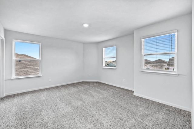 carpeted empty room with a healthy amount of sunlight