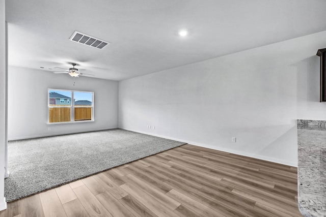 empty room featuring hardwood / wood-style flooring and ceiling fan