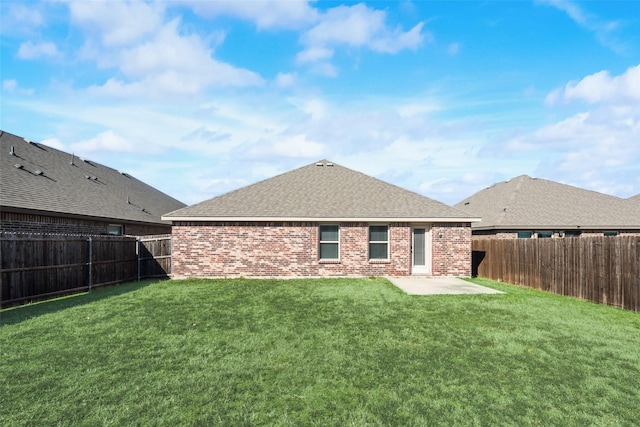 rear view of property with a patio area and a lawn