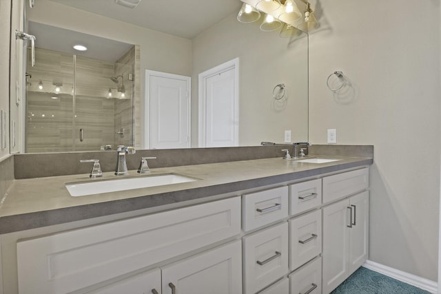 bathroom with vanity and a shower with door