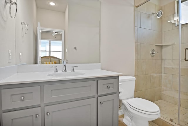 bathroom with walk in shower, vanity, and toilet