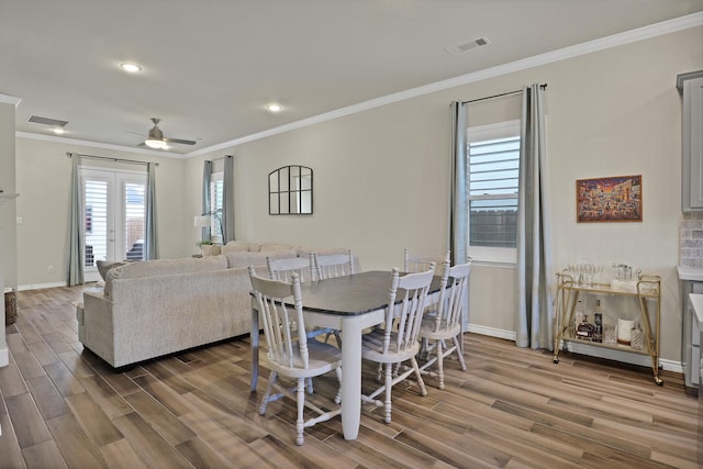 dining space featuring crown molding, hardwood / wood-style flooring, french doors, and ceiling fan